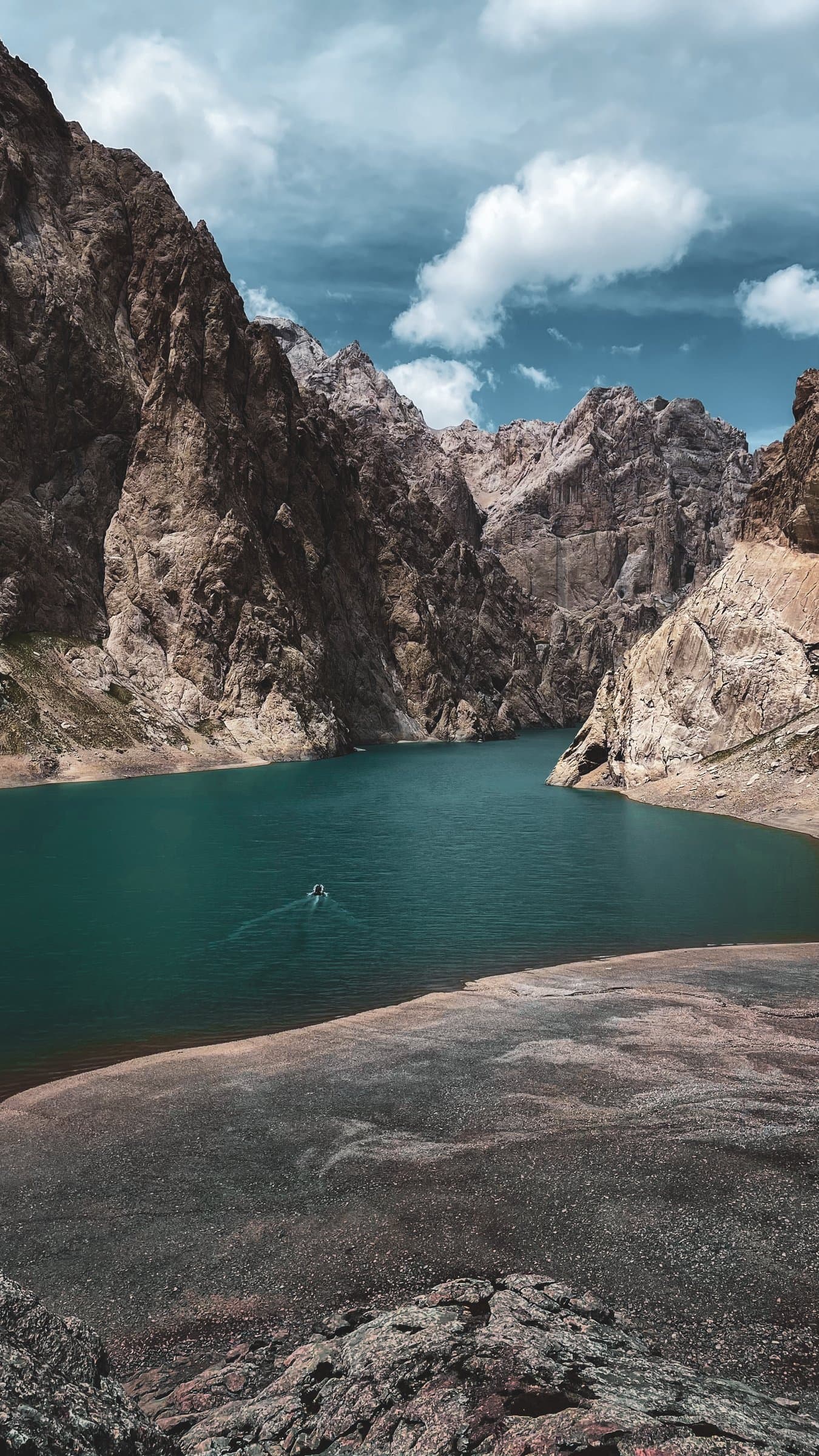 Turquoise Kel-Suu Lake held between steep rocky cliffs